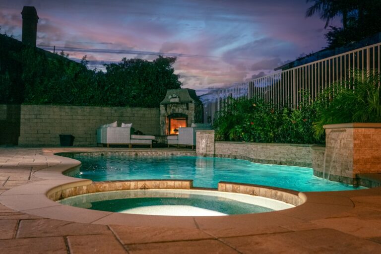 A backyard pool with a solar heating system visible on a sunny day.